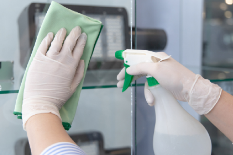 hands cleaning with green rag